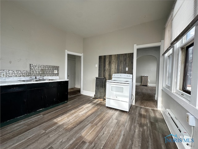 kitchen featuring dark hardwood / wood-style flooring, sink, a baseboard radiator, and white range with electric cooktop