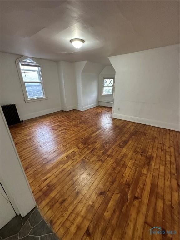 bonus room featuring hardwood / wood-style floors, plenty of natural light, and radiator