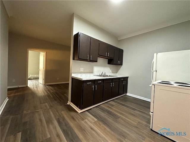 kitchen featuring sink, dark hardwood / wood-style flooring, a baseboard heating unit, dark brown cabinetry, and white appliances