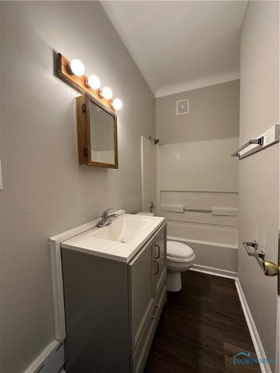 full bathroom featuring lofted ceiling, toilet, tub / shower combination, vanity, and hardwood / wood-style floors