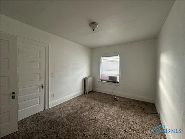 unfurnished room featuring carpet, radiator, and cooling unit