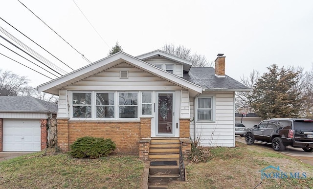 bungalow-style home with a front yard