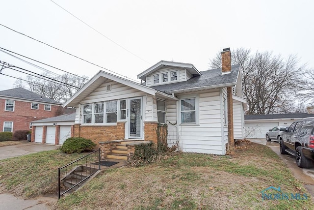 view of front of house with a garage and a front lawn