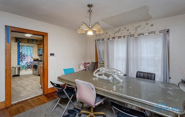 dining area featuring a notable chandelier and light wood-type flooring