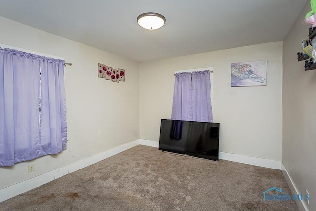 unfurnished room featuring carpet flooring