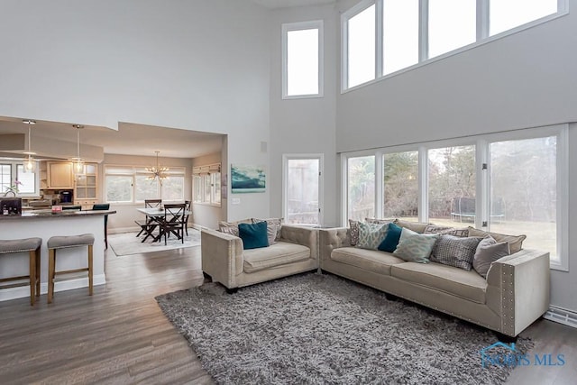 living room featuring dark hardwood / wood-style flooring and a healthy amount of sunlight