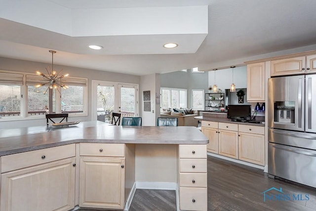 kitchen featuring light brown cabinetry, stainless steel fridge with ice dispenser, dark hardwood / wood-style flooring, a notable chandelier, and pendant lighting