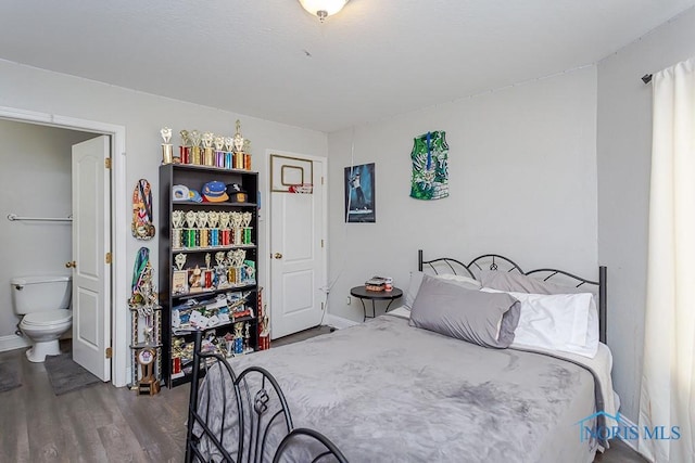 bedroom with wood-type flooring and ensuite bathroom