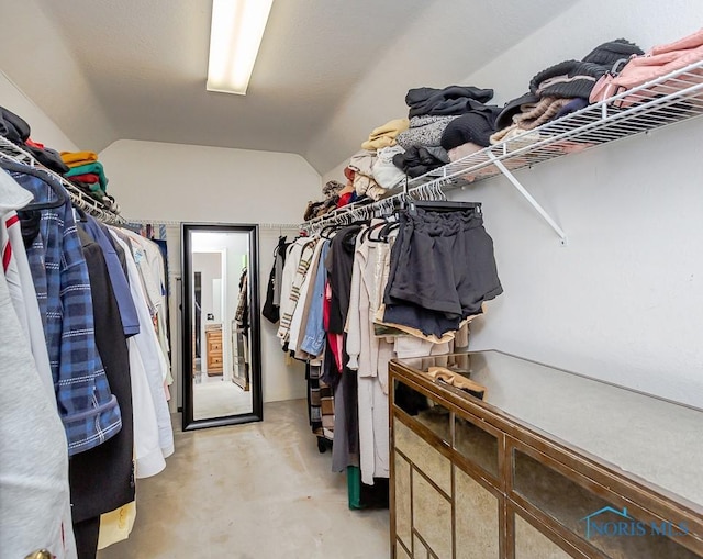 walk in closet with lofted ceiling