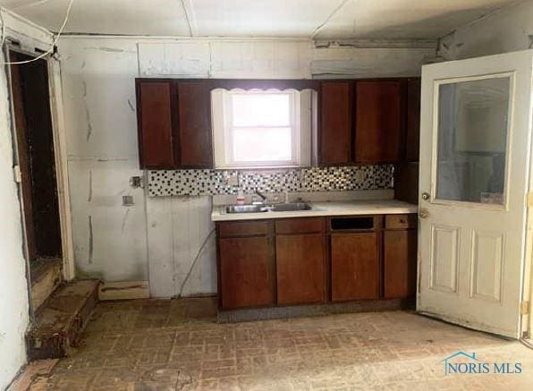 146 Railroad St, Tiffin, OH 44883 - kitchen featuring a sink, light countertops, and backsplash