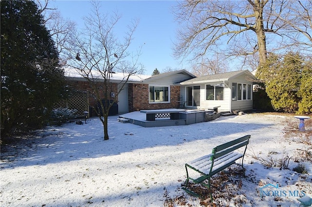 view of snow covered back of property