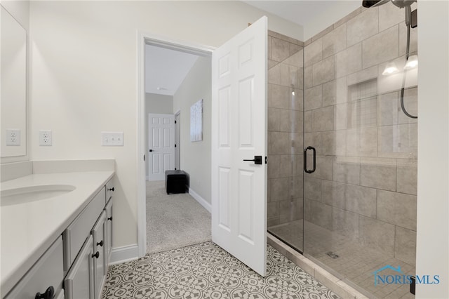 bathroom featuring vanity, tile patterned flooring, and a shower with door