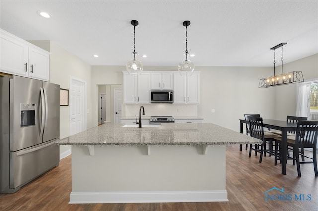 kitchen featuring stainless steel appliances, a kitchen island with sink, sink, and white cabinets