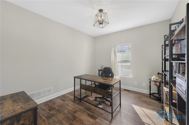 office area featuring dark hardwood / wood-style floors and an inviting chandelier