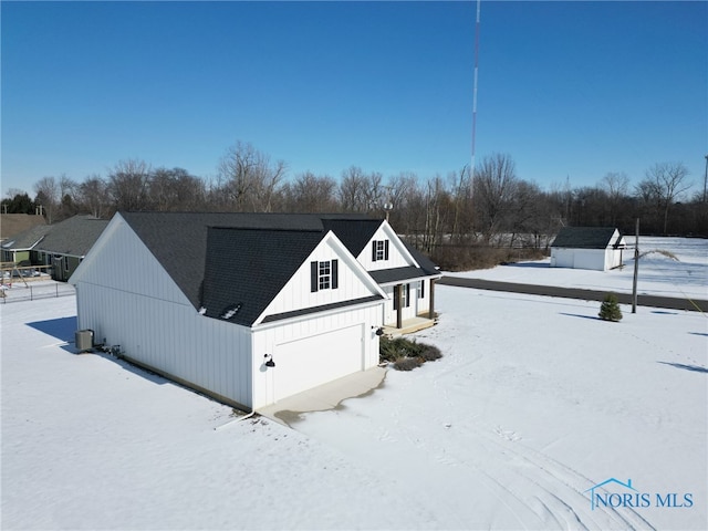 view of snowy exterior with a garage