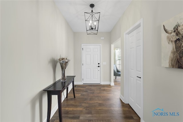 foyer featuring a notable chandelier and dark hardwood / wood-style flooring