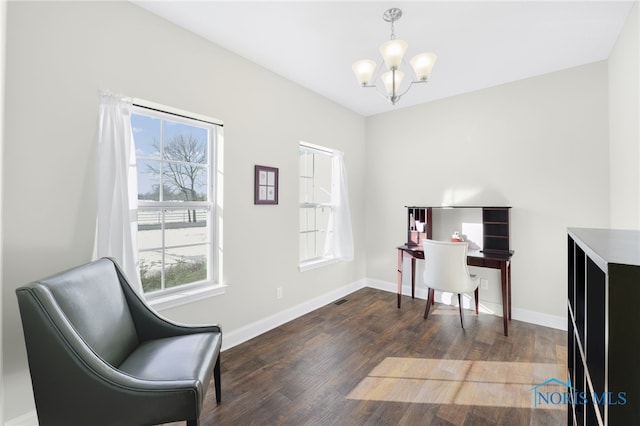 home office featuring dark wood-type flooring and a notable chandelier