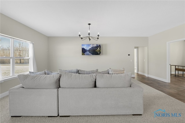 living room featuring wood-type flooring and a chandelier