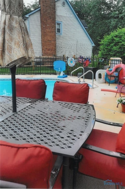 view of swimming pool with a patio