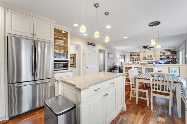 kitchen featuring light stone countertops, appliances with stainless steel finishes, pendant lighting, and white cabinets