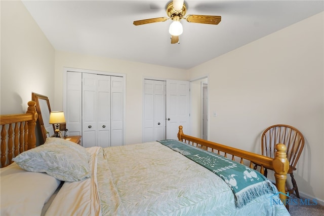 bedroom featuring two closets, carpet floors, and ceiling fan