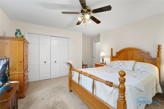 carpeted bedroom featuring ceiling fan and a closet