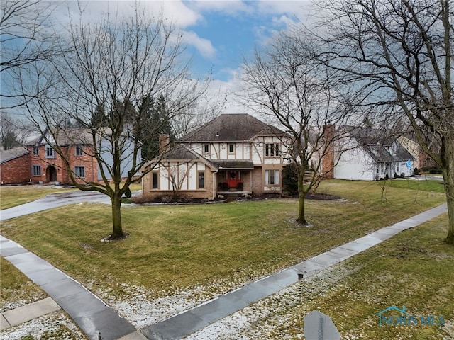 tudor home with a front yard