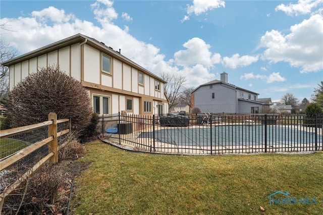 view of swimming pool with a patio and a yard