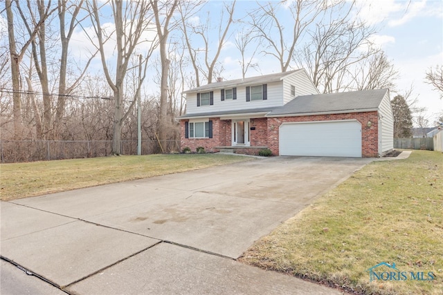 traditional home with a garage, a front yard, brick siding, and fence