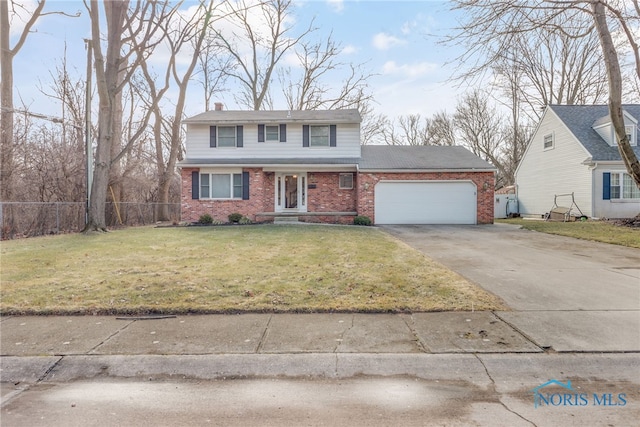 traditional home featuring a front yard, brick siding, fence, and an attached garage