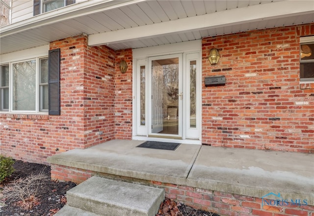 entrance to property with brick siding