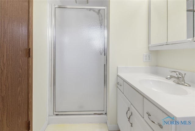 full bathroom featuring a stall shower and vanity