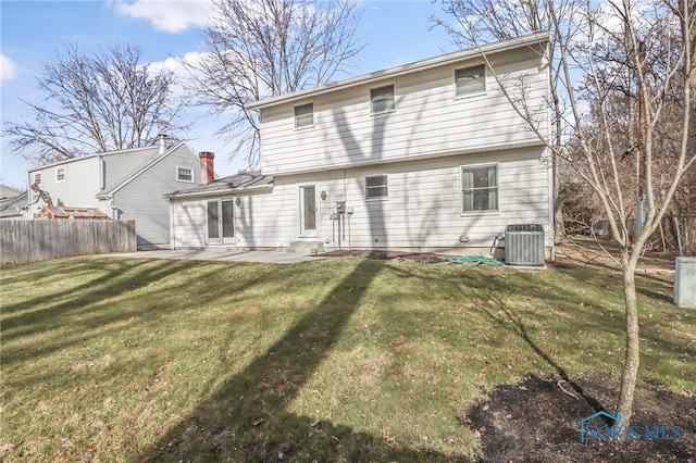 rear view of property featuring a yard, a patio, central AC unit, and fence