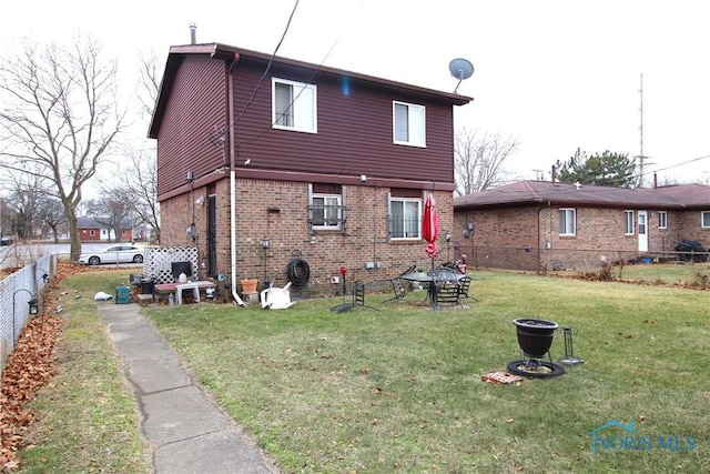 rear view of property featuring a lawn