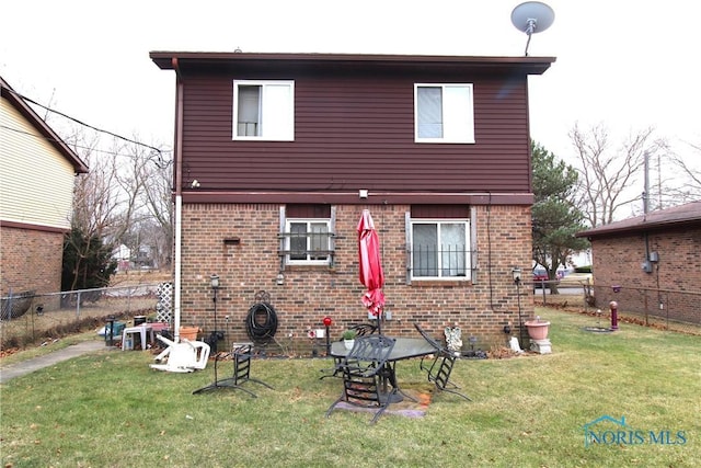 rear view of house with a yard