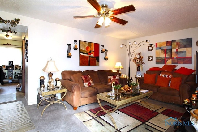 carpeted living room with ceiling fan and a textured ceiling