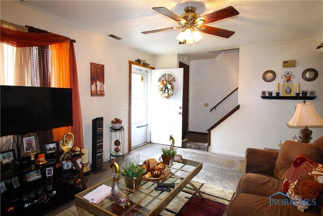 living room featuring ceiling fan, a wealth of natural light, and a textured ceiling