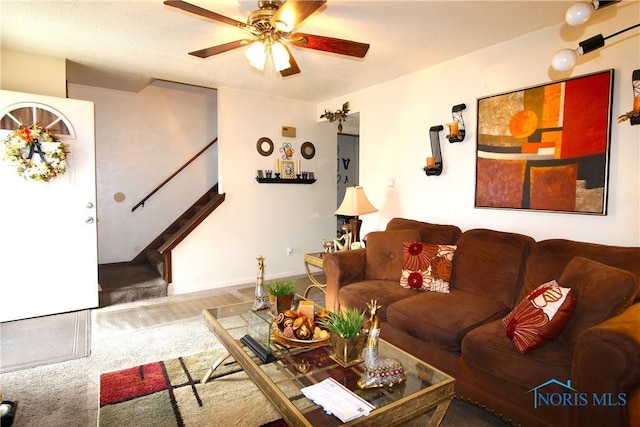 carpeted living room featuring ceiling fan