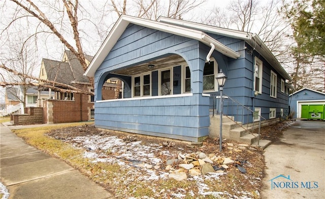 view of front of home with a garage and an outdoor structure