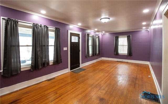 foyer featuring crown molding and hardwood / wood-style flooring