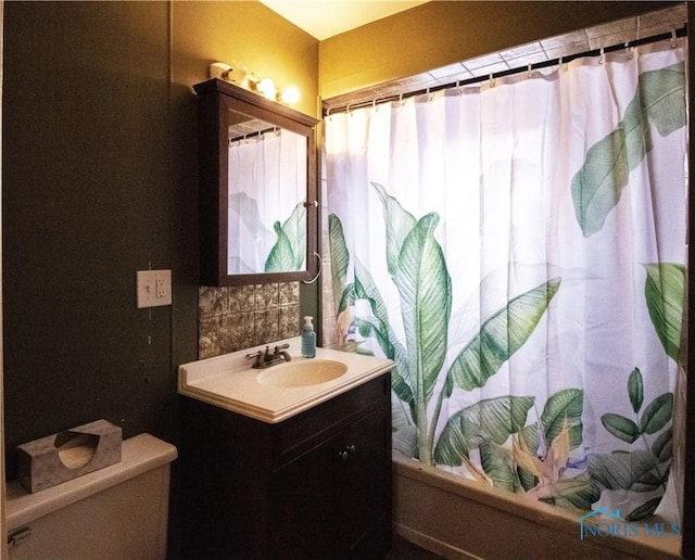 full bathroom with vanity, decorative backsplash, shower / bath combination with curtain, and toilet