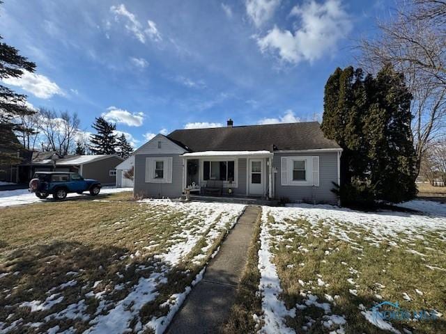 ranch-style home with a yard and covered porch