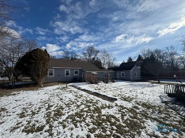 view of snow covered rear of property