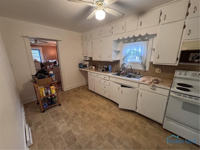 kitchen with electric range, a sink, plenty of natural light, white cabinetry, and light countertops