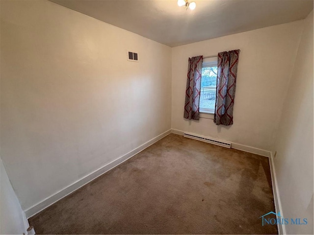 carpeted spare room with visible vents, baseboards, and a baseboard radiator