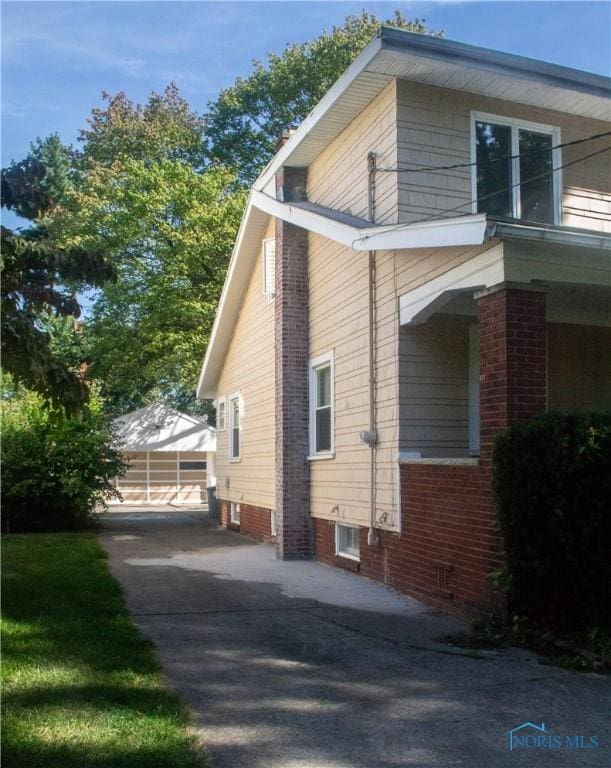 view of side of home featuring a carport