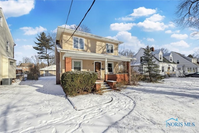 view of front property with a porch and central AC unit