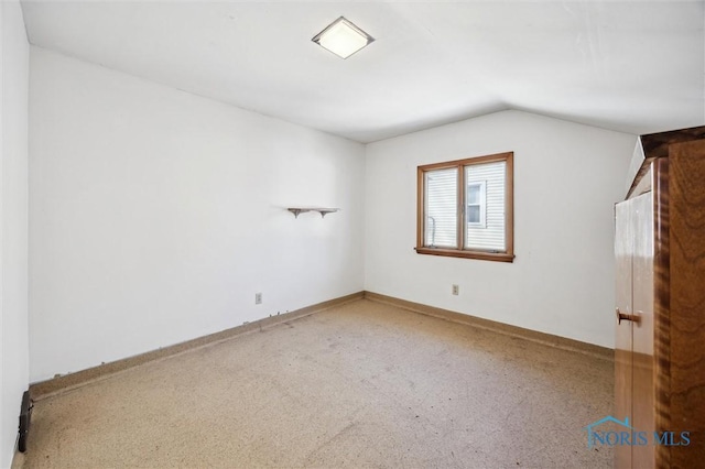 empty room with vaulted ceiling