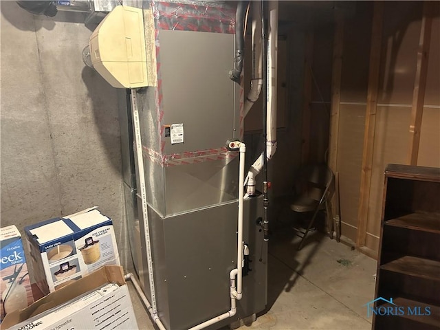 utility room featuring heating unit