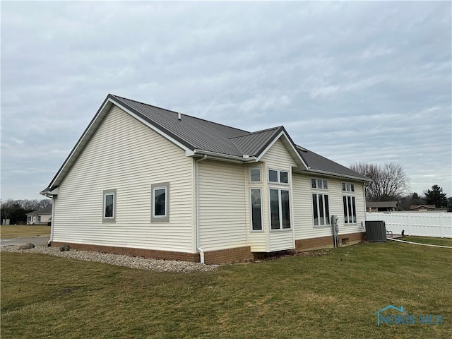 view of side of home featuring a yard and cooling unit